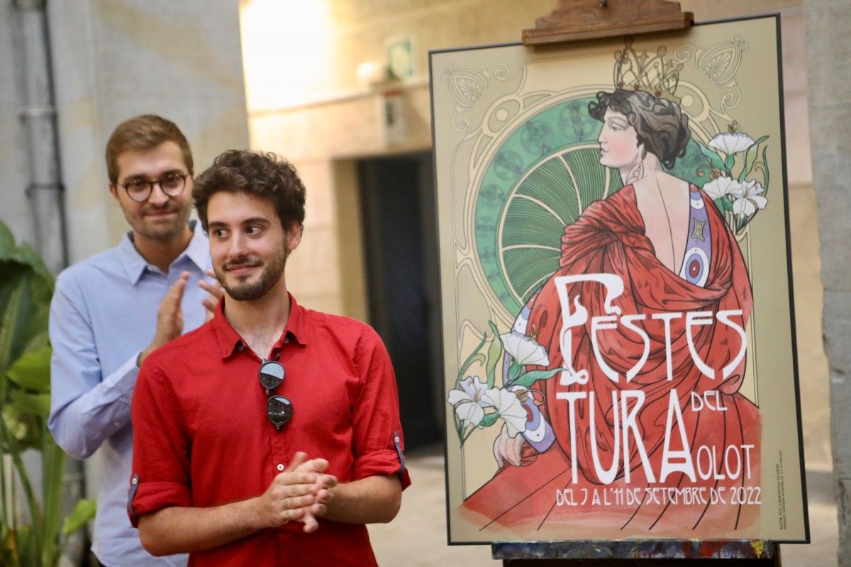Eloi Casanovas, autor del dibuix, al costat del cartell de les Festes del Tura d'Olot