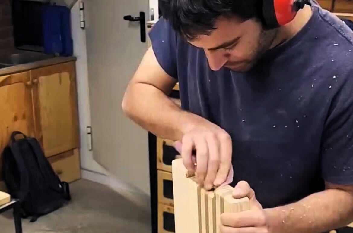 Nil Vilanova treballant una peça de fusta.