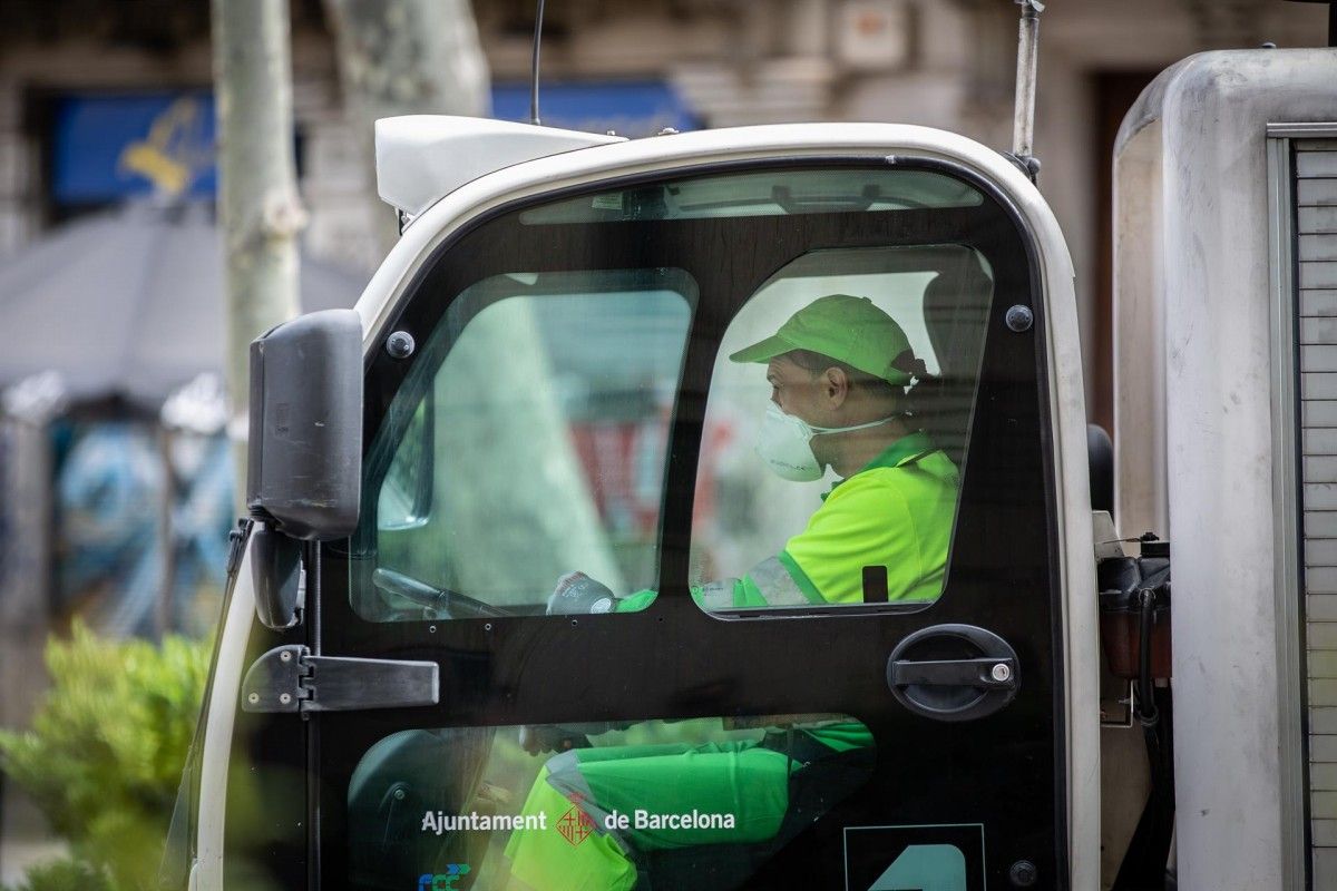 Una treballadora amb mascareta dins d'un camionet