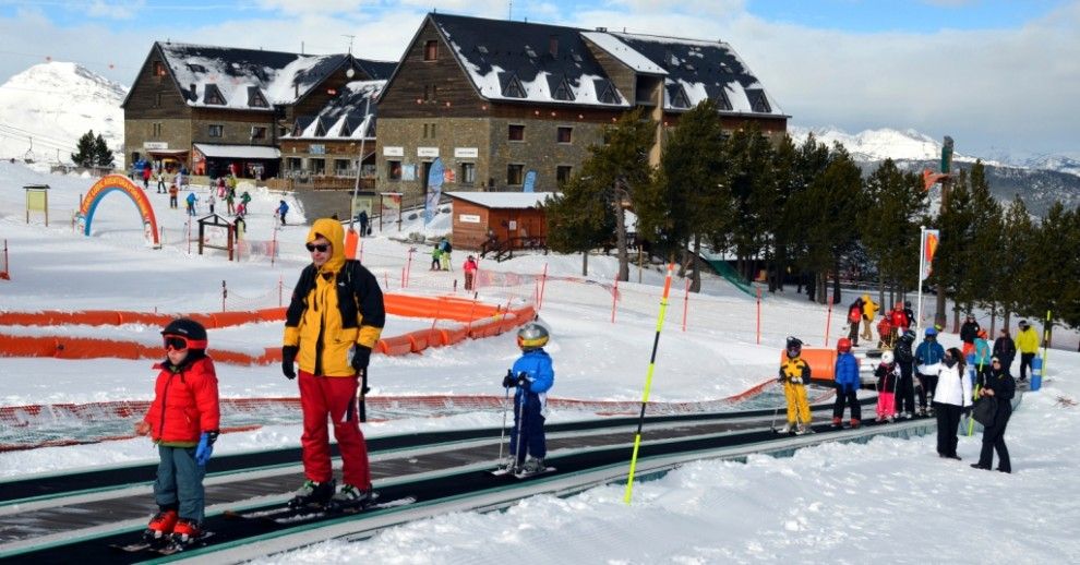 Un grup d'esquiadors pujant per la cinta a l'estació d'esquí de Port Ainé 