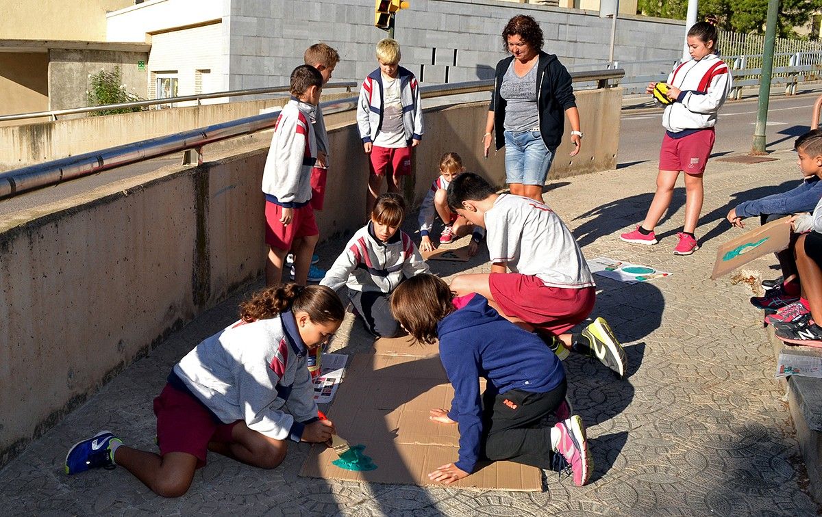 Alumnes de l'escola Francesc Macià pinten un dels itineraris dels camins escolars a peu