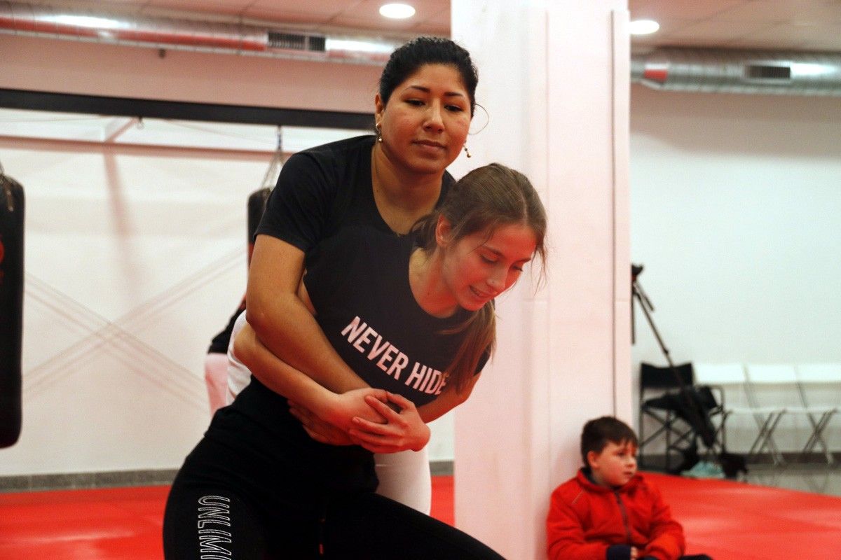 Dues de les participants del curs fent una pràctica de defensa personal