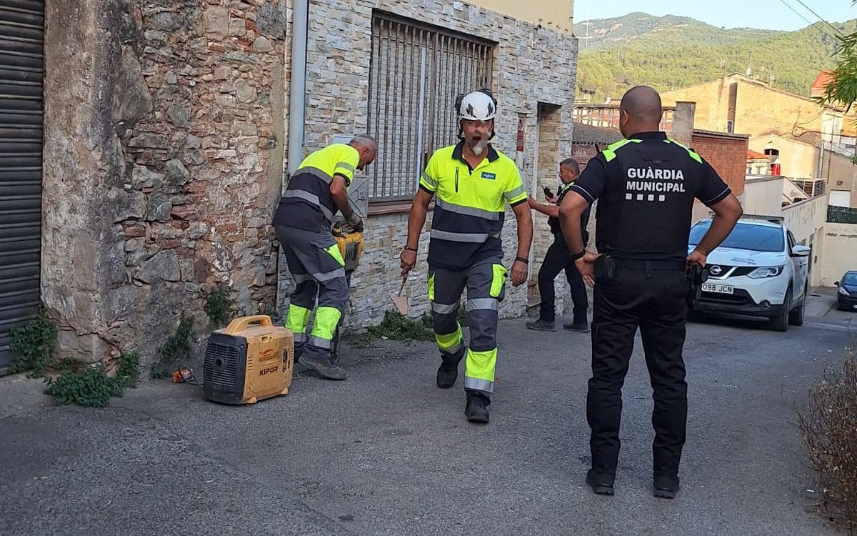 Operaris custodiats per la Guàrdia Municipal, treballant en la casa ocupada