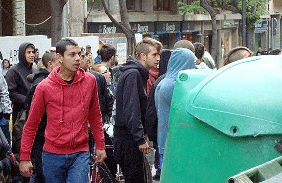 Uns joves, picants uns contenidors, en la protesta d'aquest dimarts.