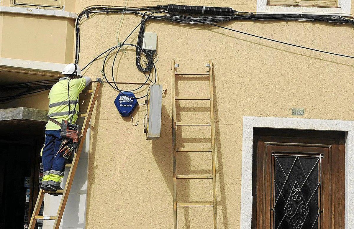 Un operari instal·lant la fibra òptica a Orís.