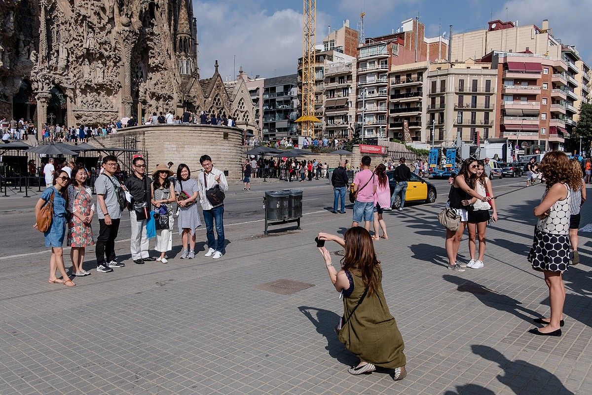 Un grup de turistes es fotografia davant la Sagrada Família