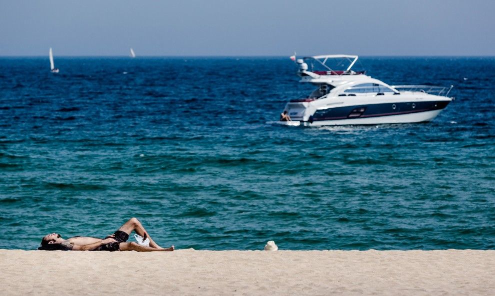 Un home prenent el sol a la platja de Badalona, en una imatge d'arxiu