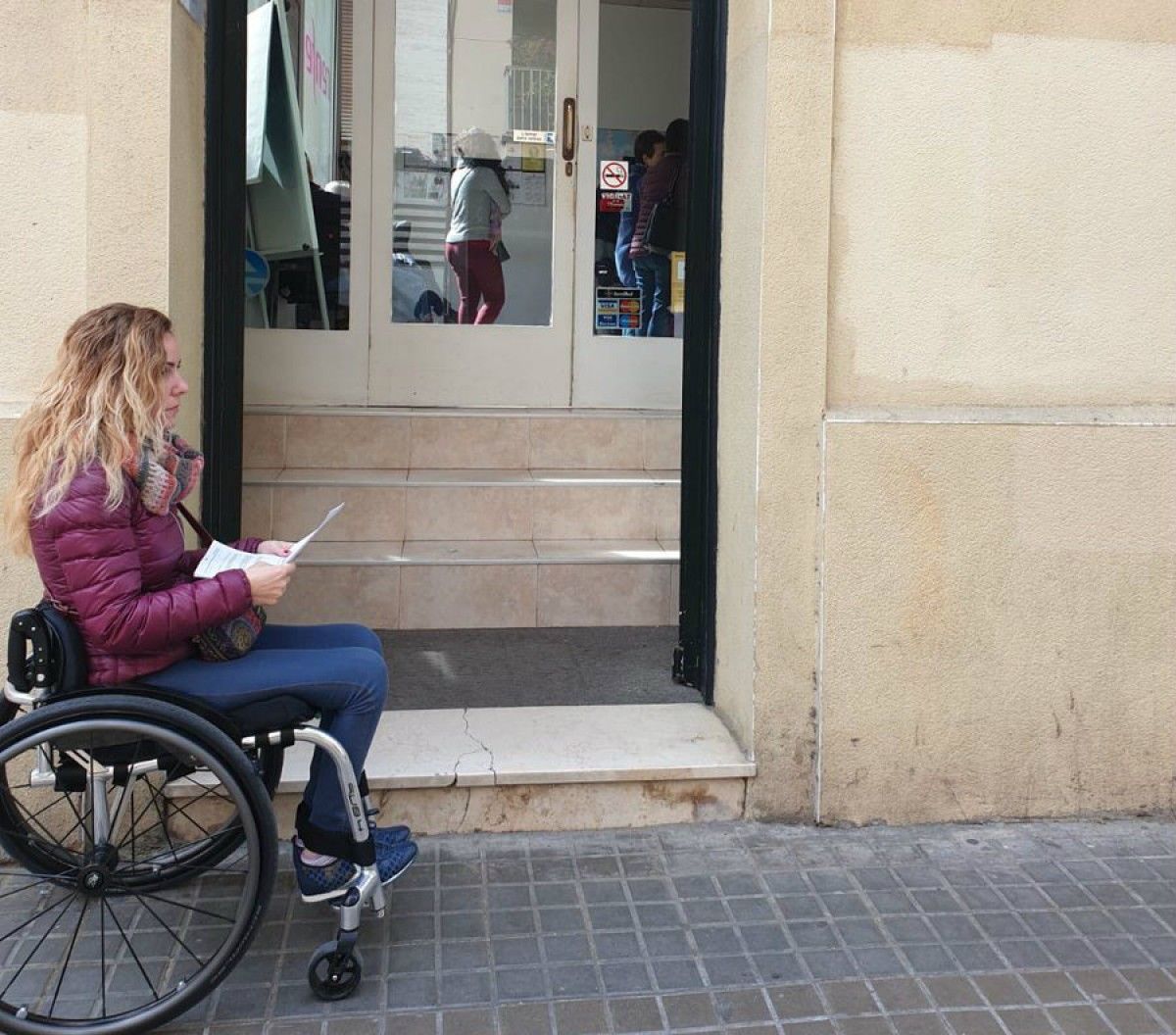Mireia Sanz esperant fora de l'establiment on compra bitllets de Renfe