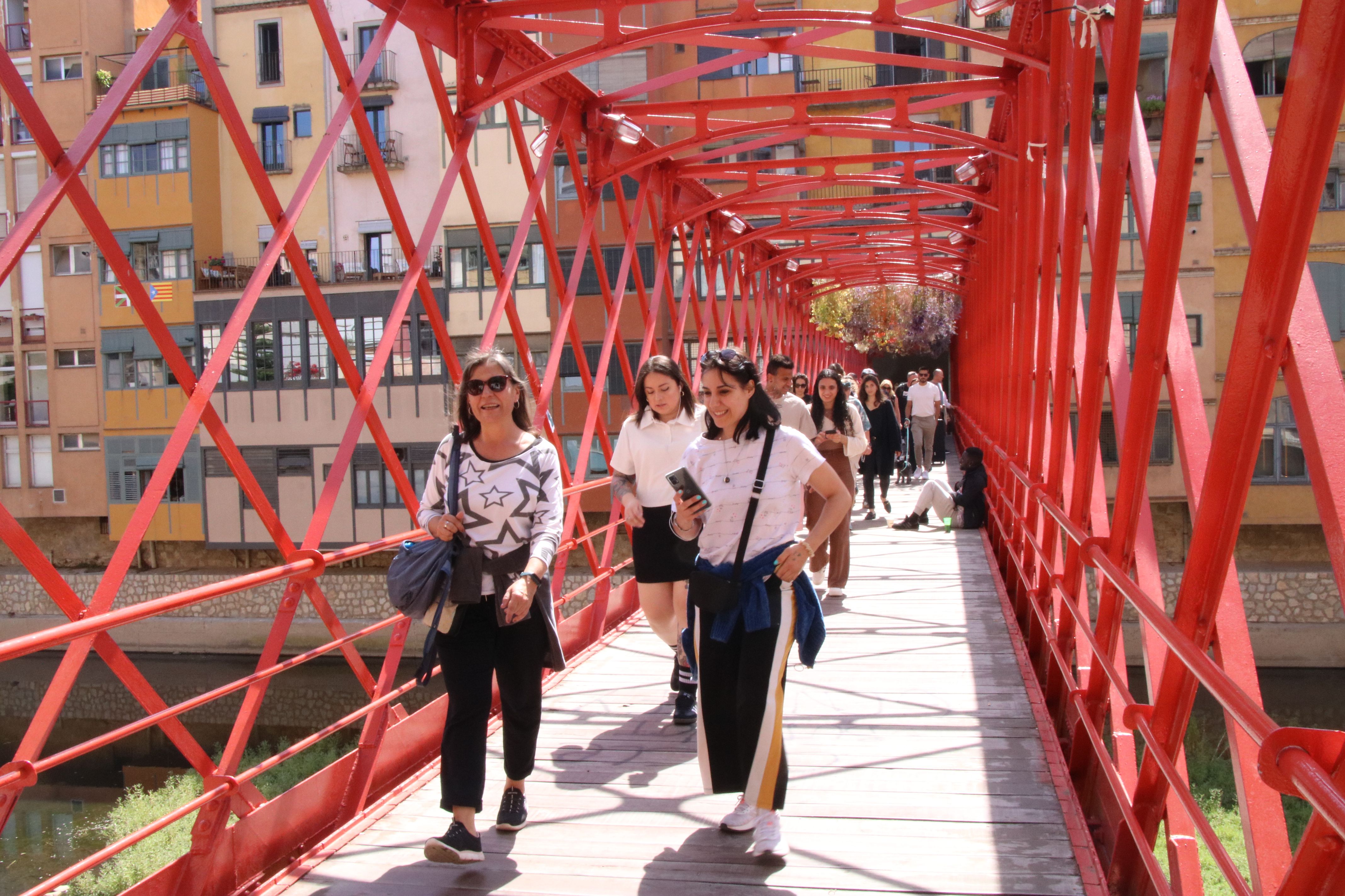  Visitants travessant el pont de les peixetaries velles a Girona l'últim dia de Temps de Flors