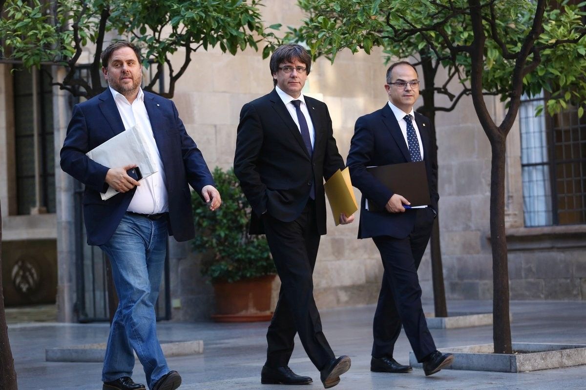 Carles Puigdemont, Oriol Junqueras i Jordi Turull caminen cap a una reunió del Govern