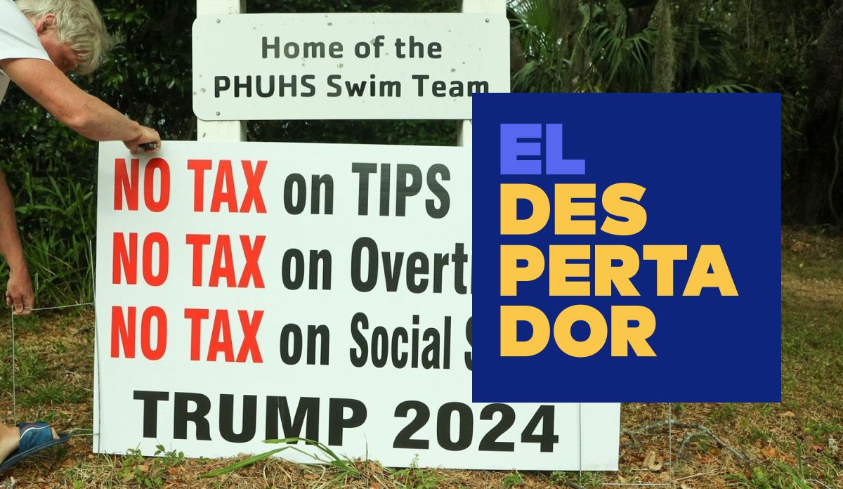 Un home planta un cartell a favor de Trump a Palm Harbor, en plena jornada electoral