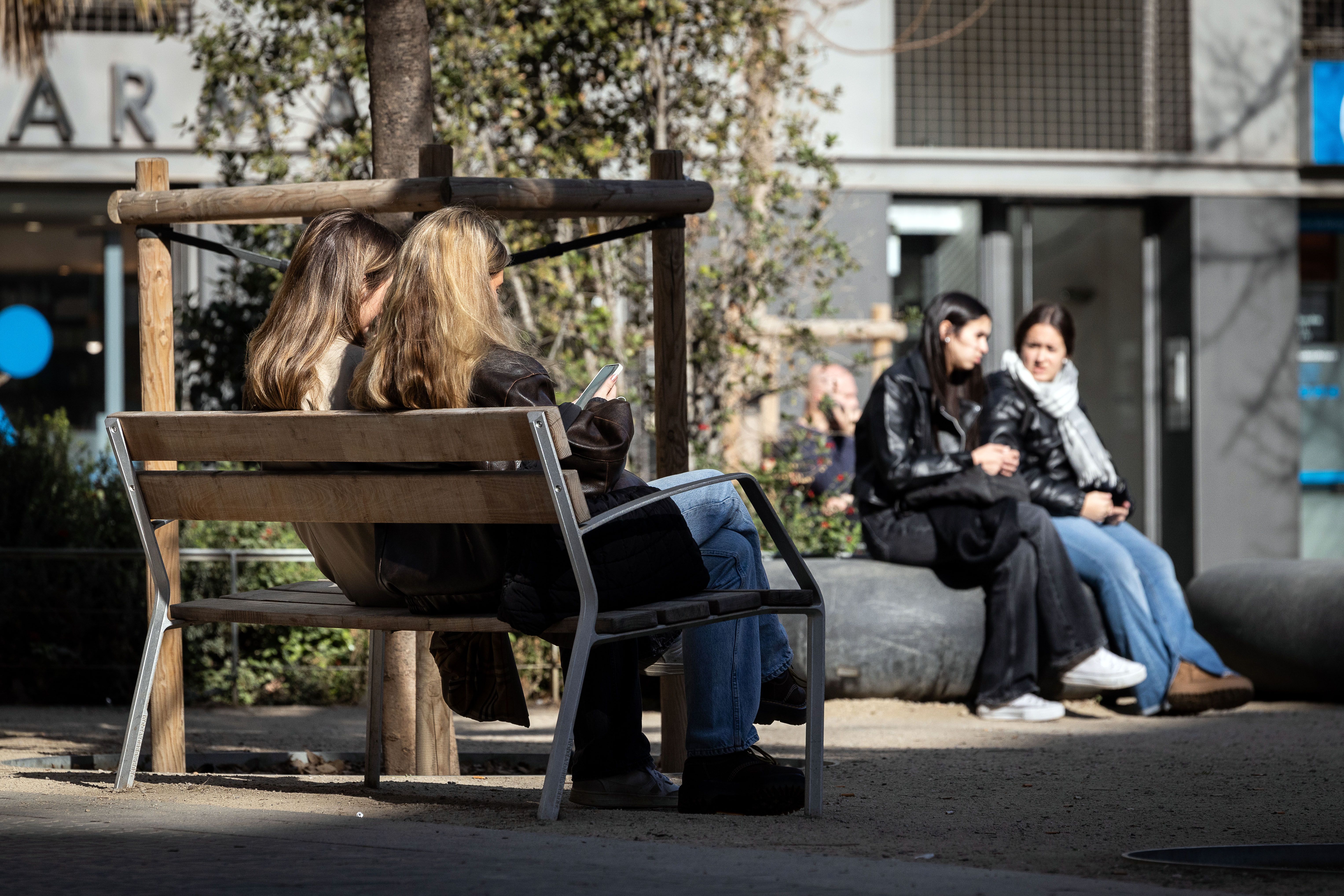 Joves parlant, amb el mòbil a la mà, a Barcelona