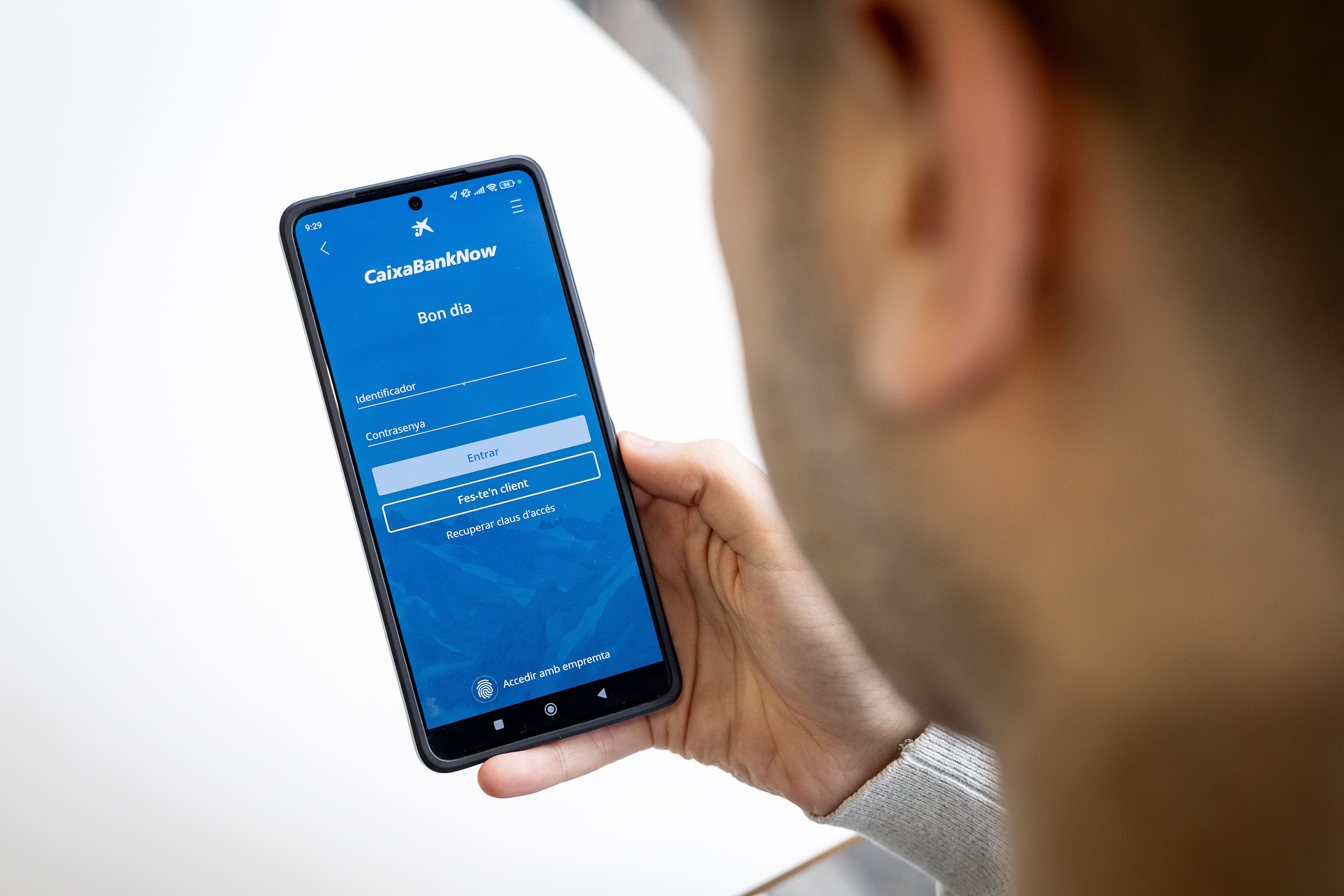 Un usuari consulta l'App de Caixa Bank